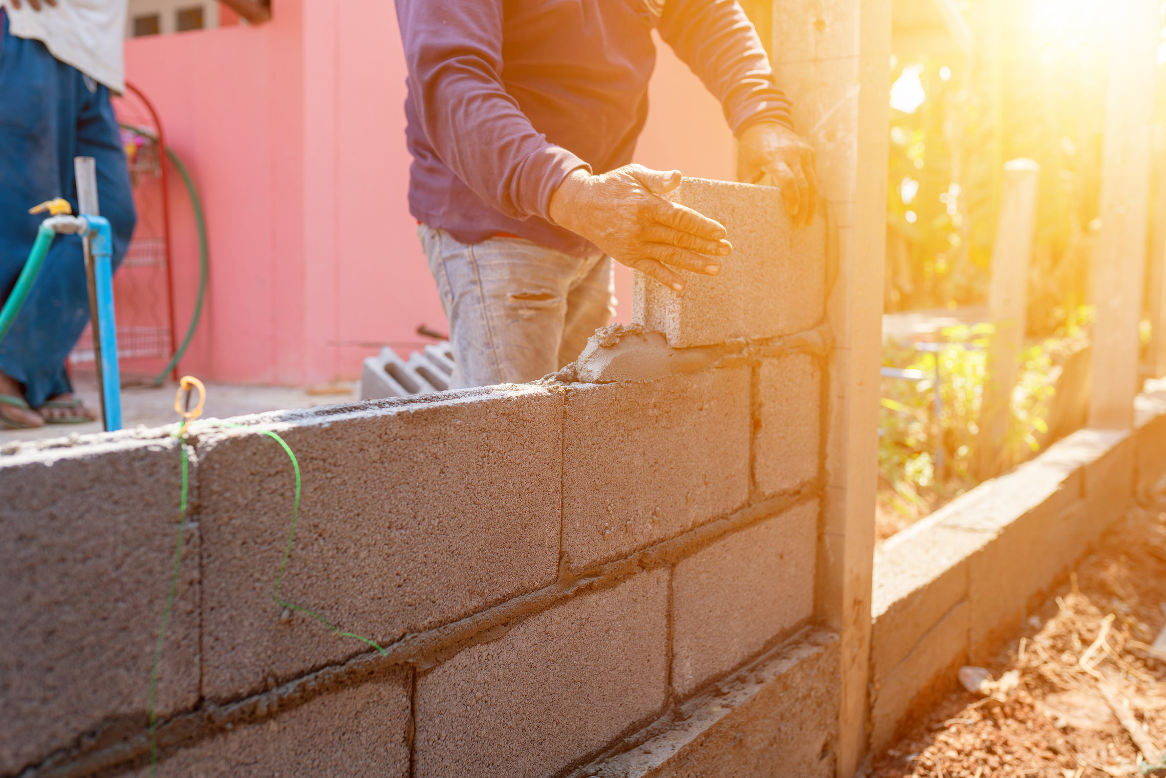 Masoners constructing masonry to build fences